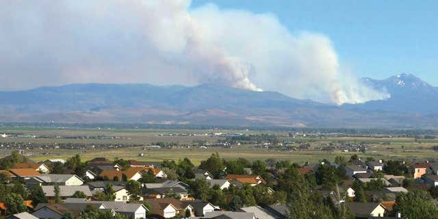 June 22, 2015: Smoke from the Washington Fire rises over the mountains in Markleeville, Calif.