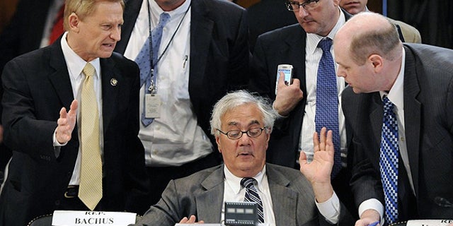June 24: House Financial Services Committee Chairman Barney Frank talks with a group lawmakers, including Ranking Member Spencer Bachus, left, during a committee conference on Wall Street reform on Capitol Hill.