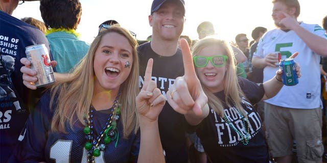 Jan 7, 2013; Miami, FL, USA; Notre Dame Fighting Irish fans Eileen Veihmeyer (left), Patrick Veihmeyer (center), and Abigail Chappell pose for a photo before the 2013 BCS Championship game against the Alabama Crimson Tide at Sun Life Stadium. Mandatory Credit: Steve Mitchell-USA TODAY Sports