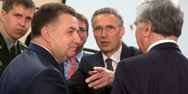 June 25, 2015: NATO Secretary General Jens Stoltenberg, second right, speaks with Ukraine's Defense Minister Stepan Poltorak, second left, during a meeting of the NATO-Ukraine Commission at NATO headquarters in Brussels.