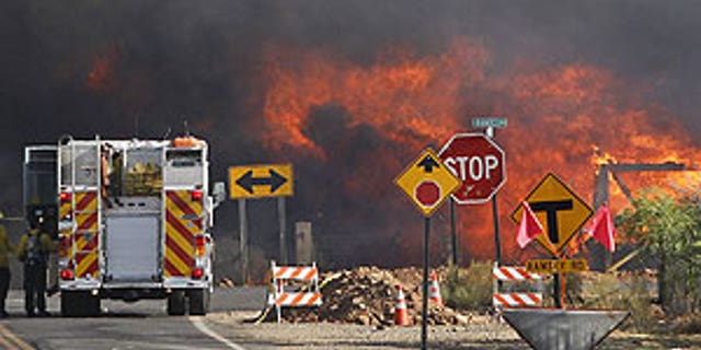 June 19: A home burns at the intersection of Campbello Ave. and Ramsey Rd. from the Monument Fire near Sierra Vista, Ariz.
