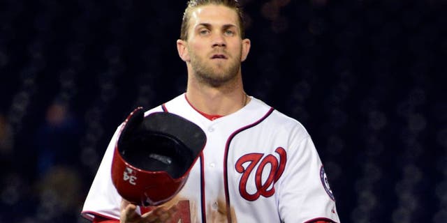 Apr 24, 2014; Washington, DC, USA; Washington Nationals left fielder Bryce Harper (34) walks off the field after being thrown out at second base in the twelfth inning to end the game against the San Diego Padres at Nationals Park. San Diego Padres defeated Washington Nationals 4-3. Mandatory Credit: Tommy Gilligan-USA TODAY Sports