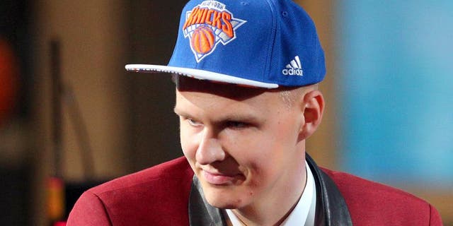 Jun 25, 2015; Brooklyn, NY, USA; Kristaps Porzingis (SPN) reacts after being selected as the number four overall pick to the Miami Heat in the first round of the 2015 NBA Draft at Barclays Center. Mandatory Credit: Brad Penner-USA TODAY Sports