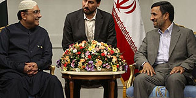 June 24: Iranian President Mahmoud Ahmadinejad, right, and his Pakistani counterpart Asif Ali Zardari meet at the Iranian presidency office in Tehran, Iran. At center is an unidentified interpreter.