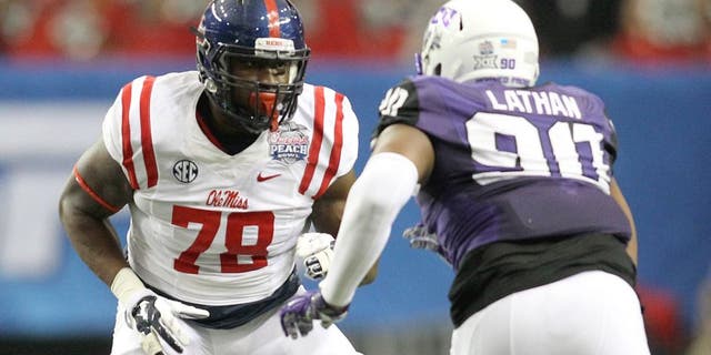 Dec 31, 2014; Atlanta , GA, USA; Mississippi Rebels offensive lineman Laremy Tunsil (78) prepares to block TCU Horned Frogs defensive tackle Terrell Lathan (90) during the first quarter in the 2014 Peach Bowl at the Georgia Dome. Mandatory Credit: Brett Davis-USA TODAY Sports