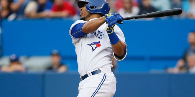 Jun 26, 2015; Toronto, Ontario, CAN; Toronto Blue Jays designated hitter Edwin Encarnacion (10) hits a grand slam homerun in the first inning against the Texas Rangers at Rogers Centre. Mandatory Credit: John E. Sokolowski-USA TODAY Sports