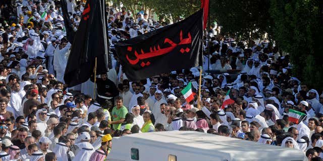 June 27, 2015: Thousands of Sunnis and Shiites from across the country take part in a mass funeral procession for 27 people killed in a suicide bombing that targeted the Shiite Imam Sadiq Mosque a day earlier, at the Grand Mosque in Kuwait City, Kuwait.