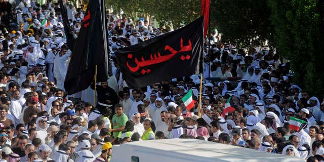 June 27, 2015: Thousands of Sunnis and Shiites from across the country take part in a mass funeral procession for 27 people killed in a suicide bombing that targeted the Shiite Imam Sadiq Mosque a day earlier, at the Grand Mosque in Kuwait City, Kuwait.
