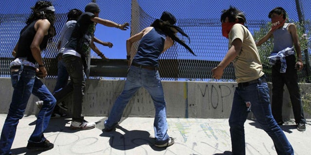 June 12: Mexicans are seen damaging the U.S. border fence, during a protest on the outskirts of Ciudad Juarez.