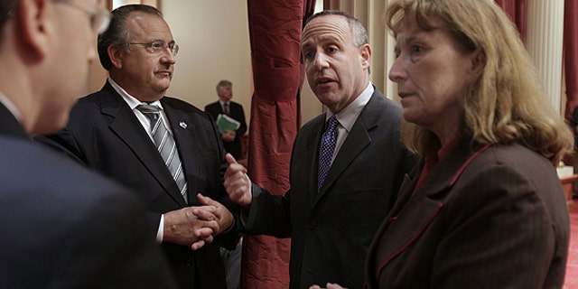 June 28: State Senate President Pro Tem Darrell Steinberg, D-Sacramento, second right, confers with Senate Minority Leader Bob Dutton, R-Rancho Cucamonga, second left, Repulican Senate Caucus Chief of Staff Kevin Bassett, left, and Sen. Ellen Corbett, D-San Leandro, at the Capitol in Sacramento, Calif.