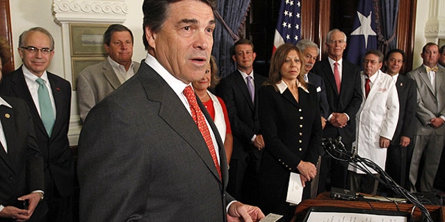 In this May 30, 2011 photo Texas Gov. Rick Perry speaks at a news conference before signing a tort reform bill at the Capitol in Austin, Texas.
