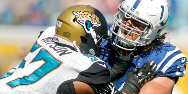 Sep 21, 2014; Jacksonville, FL, USA; Jacksonville Jaguars linebacker Dekoda Watson (57) is blocked by Indianapolis Colts tackle Anthony Castonzo (74) in the fourth quarter of their game at EverBank Field. The Colts won 44-17. Mandatory Credit: Phil Sears-USA TODAY Sports