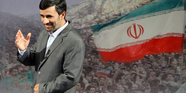 June 28: Iranian President Mahmoud Ahmadinejad gestures after speaking to the press in Tehran.