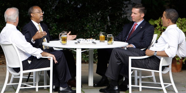 In this July 30, 2009 file photo, President Obama, right, and Vice President Biden, left, have a beer with Harvard scholar Henry Louis Gates Jr., second from left, and Cambridge, Mass., police Sgt. James Crowley in the Rose Garden of the White House in Washington.