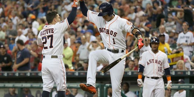 Jun 29, 2015; Houston, TX, USA; Houston Astros shortstop Carlos Correa (1) celebrates with second baseman Jose Altuve (27) after a home-run against the Kansas City Royals in the third inning at Minute Maid Park. Mandatory Credit: Thomas B. Shea-USA TODAY Sports