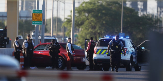 Chicago police work at the scene of a shooting that killed multiple people on the Chicago Skyway early Wednesday, June 21, 2017, in Chicago. The shooting prompted an early-morning closure of part of the expressway that connects the city with Indiana. (Alyssa Pointer/Chicago Tribune via AP)