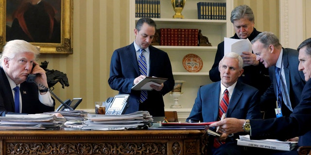 JANUARY 2017: U.S. President Donald Trump (L-R), joined by Chief of Staff Reince Priebus, Vice President Mike Pence, senior advisor Steve Bannon, Communications Director Sean Spicer and National Security Advisor Michael Flynn in the Oval Office in January 2017.