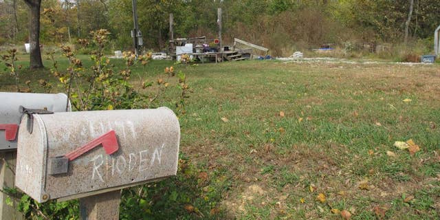 In this Tuesday, Oct. 18, 2016 photo, a porch is all that remains of the home on Union Hill Road after investigators removed the trailer where the bodies of Clarence 