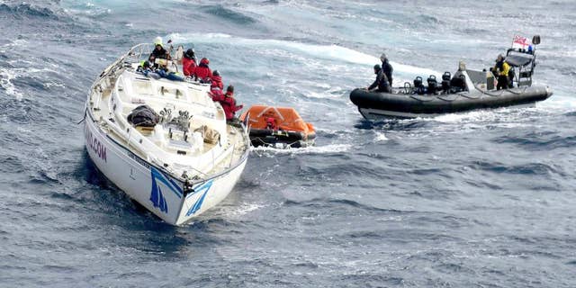In this photo provided by the Ministry of Defence on Sunday, Feb. 12, 2017, crew from the Royal Navy's Type 45 destroyer HMS Dragon, man a large sea boat as they help to rescue crew members from a racing yacht in the Atlantic Ocean. Britain's Royal Navy says a warship has rescued 14 sailors after their racing yacht lost its mast, leaving them stranded in the mid- Atlantic. Britain's Coast Guard received a mayday signal from the 60-foot (18-meter) Clyde Challenger late Thursday. (Royal Navy/MOD via AP)