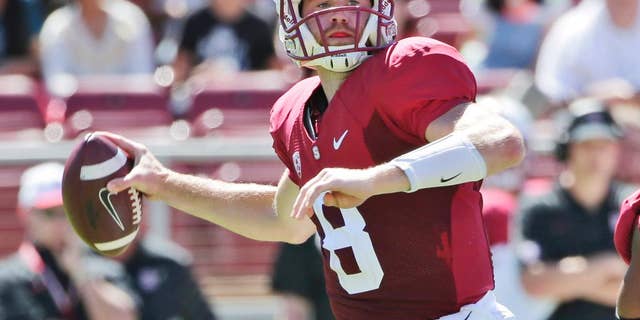 Stanford quarterback Kevin Hogan throws against UC Davis during the first half of an NCAA college football game on Saturday, Aug. 30, 2014, in Stanford, Calif. (AP Photo/Marcio Jose Sanchez)