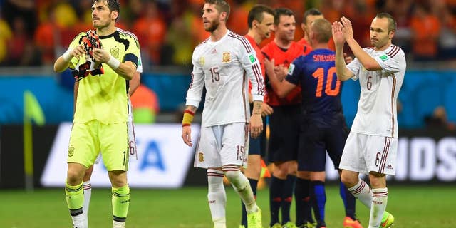 Spain's goalkeeper Iker Casillas, left, Spain's Sergio Ramos, centre and Spain's Andres Iniesta react after the group B World Cup soccer match between Spain and the Netherlands at the Arena Ponte Nova in Salvador, Brazil, Friday, June 13, 2014. The Netherlands won the match 5-1. (AP Photo/Manu Fernandez)