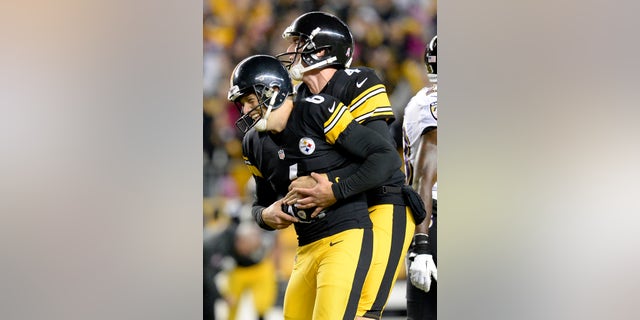 Pittsburgh Steelers holder Zoltan Mesko, right, celebrates with kicker Shaun Suisham after Suisham kicks the winning field goal against the Baltimore Ravens in the fourth quarter of an NFL football game on Sunday, Oct. 20, 2013, in Pittsburgh. The Steelers won 19-16. (AP Photo/Don Wright)