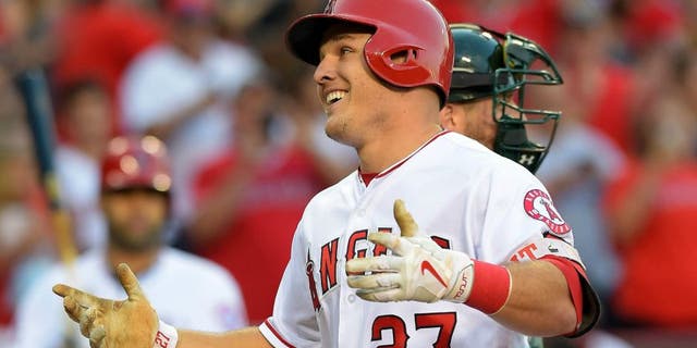 Jun 25, 2016; Anaheim, CA, USA; Los Angeles Angels center fielder Mike Trout (27) crosses the plate after a solo home run off Oakland Athletics relief pitcher Dillon Overton (47) in the first inning of the game at Angel Stadium of Anaheim. Mandatory Credit: Jayne Kamin-Oncea-USA TODAY Sports