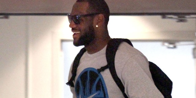 July 2: Free agent basketball player LeBron James makes his way through the IMG building to talk with the Miami Heat in Cleveland.