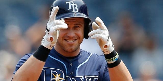 Tampa Bay Rays designated hitter Evan Longoria gestures toward the dugout after hitting a first-inning double in a baseball game against the New York Yankees at Yankee Stadium in New York, Sunday, July 5, 2015. (AP Photo/Kathy Willens)