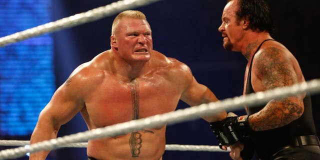 NEW YORK, NY - AUGUST 23: Brock Lesnar and The Undertaker battle it out at the WWE SummerSlam 2015 at Barclays Center of Brooklyn on August 23, 2015 in New York City. (Photo by JP Yim/Getty Images)
