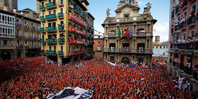 July 6: Revelers hold up traditional red neckties during the 'Chupinazo', the official opening of the 2010 San Fermin fiestas in Pamplona, Spain.