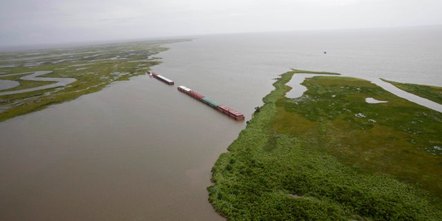 July 6: Barges lined up to block oil are seen from the air in Chef Menteur Pass, which connects the Gulf of Mexico and Lake Borgne to Lake Pontchartrain, in New Orleans, La.