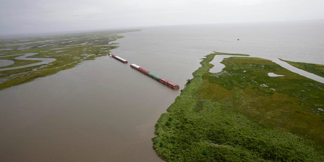 July 6: Barges lined up to block oil are seen from the air in Chef Menteur Pass, which connects the Gulf of Mexico and Lake Borgne to Lake Pontchartrain, in New Orleans, La.