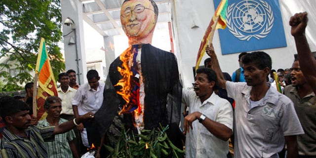 July 6: Sri Lankan protesters wave their national flags and burn an effigy of U.N. Secretary General Ban Ki-moon outside the U.N. office in Colombo, Sri Lanka.