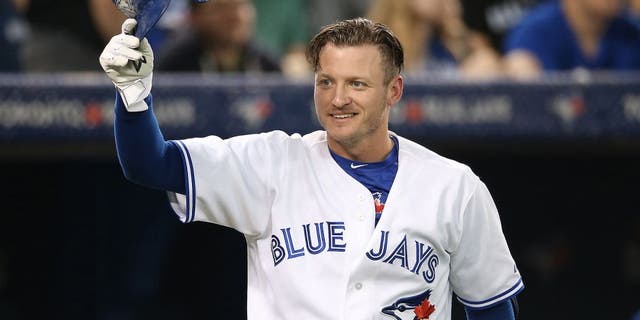 TORONTO, CANADA - JUNE 8: Josh Donaldson #20 of the Toronto Blue Jays greets a member of the Miami Marlins as he tips his helmet during MLB game action against the Miami Marlins on June 8, 2015 at Rogers Centre in Toronto, Ontario, Canada. (Photo by Tom Szczerbowski/Getty Images)
