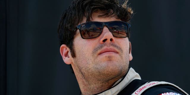 FORT WORTH, TX - JUNE 10: John Wes Townley, driver of the #05 Jive Communications/Zaxbys Chevrolet, stands on the grid during Star-Telegram Qualifying for the NASCAR Camping World Truck Series Rattlesnake 400 at Texas Motor Speedway on June 10, 2016 in Fort Worth, Texas. (Photo by Matt Hazlett/Getty Images for Texas Motor Speedway)