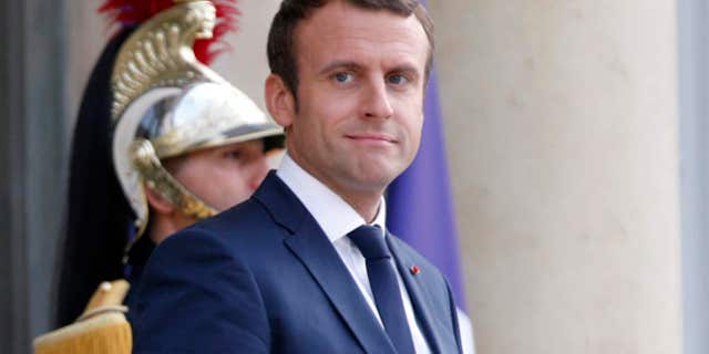 France's President Emmanuel Macron waits prior to welcoming Mexico's President Enrique Pena Nieto, for a dinner at the Elysee Palace, in Paris, Thursday, July 6, 2017.
