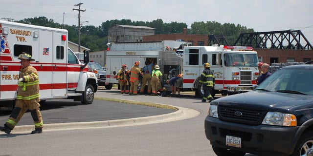 July 7: Emergency personnel unpack equipment from their vehicle at the site of a roof collapse at a factory on Front Street in Fremont, Ohio.