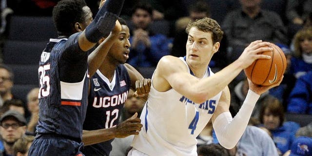Feb 19, 2015; Memphis, TN, USA; Connecticut Huskies forward Kentan Facey (12) guards Memphis Tigers forward Austin Nichols (4) during the game at FedExForum. Mandatory Credit: Justin Ford-USA TODAY Sports