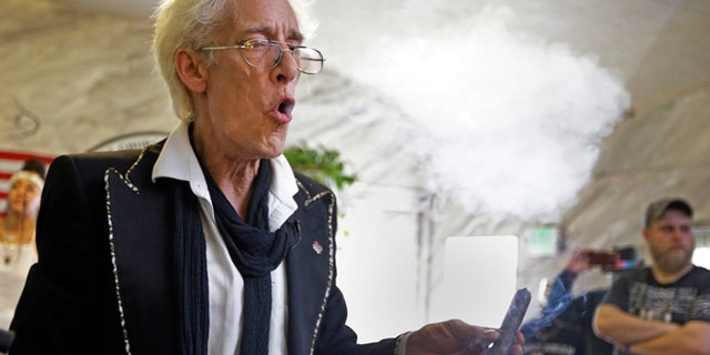 July 1, 2015: First Church of Cannabis Founder Bill Levin exhales as he smokes a "sacrament substitute" during the church's first service in Indianapolis.