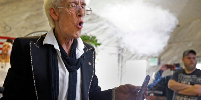 July 1, 2015: First Church of Cannabis Founder Bill Levin exhales as he smokes a "sacrament substitute" during the church's first service in Indianapolis.