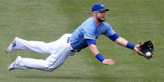 Kansas City Royals left fielder Alex Gordon (4) makes a diving catch for an out on Minnesota Twins' Trevor Plouffe during the fourth inning on Sunday, July 5, 2015 at Kauffman Stadium in Kansas City, Mo. (John Sleezer/Kansas City Star/TNS via Getty Images)