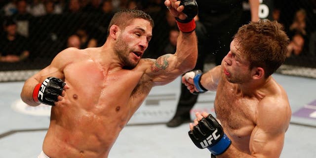 SACRAMENTO, CA - DECEMBER 14: (L-R) Chad Mendes punches Nik Lentz in their featherweight bout during the UFC on FOX event at Sleep Train Arena on December 14, 2013 in Sacramento, California. (Photo by Josh Hedges/Zuffa LLC/Zuffa LLC via Getty Images)