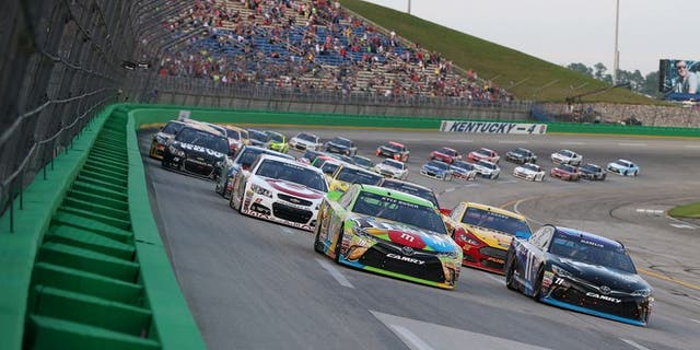 SPARTA, KY - JULY 11: Kyle Busch, driver of the #18 M&M's Crispy Toyota, and Denny Hamlin, driver of the #11 FedEx Office Toyota, lead the field on a restart during the NASCAR Sprint Cup Series Quaker State 400 presented by Advance Auto Parts at Kentucky Speedway on July 11, 2015 in Sparta, Kentucky. (Photo by Brian Lawdermilk/NASCAR via Getty Images)