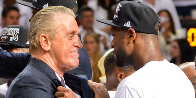 MIAMI, FL - JUNE 20: Dwyane Wade #3 and team President Pat Riley of the Miami Heat celebrate following their team's victory against the San Antonio Spurs in Game Seven of the 2013 NBA Finals on June 20, 2013 at American Airlines Arena in Miami, Florida. NOTE TO USER: User expressly acknowledges and agrees that, by downloading and or using this photograph, User is consenting to the terms and conditions of the Getty Images License Agreement. Mandatory Copyright Notice: Copyright 2013 NBAE (Photo by Jesse D. Garrabrant/NBAE via Getty Images)