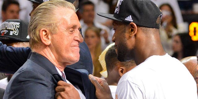 MIAMI, FL - JUNE 20: Dwyane Wade #3 and team President Pat Riley of the Miami Heat celebrate following their team's victory against the San Antonio Spurs in Game Seven of the 2013 NBA Finals on June 20, 2013 at American Airlines Arena in Miami, Florida. NOTE TO USER: User expressly acknowledges and agrees that, by downloading and or using this photograph, User is consenting to the terms and conditions of the Getty Images License Agreement. Mandatory Copyright Notice: Copyright 2013 NBAE (Photo by Jesse D. Garrabrant/NBAE via Getty Images)