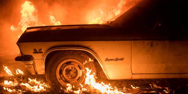 Flames from a wildfire consume a car near Oroville, Calif., on Saturday, July 8, 2017.
