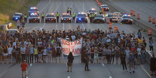 Marchers block part of Interstate 94 in St. Paul, Minn., Saturday, July 9, 2016, during a protest sparked by the recent police killings of black men in Minnesota and Louisiana.