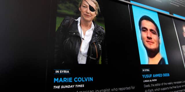 FILE- In this May 13, 2013, file photo, the photo of Journalist Marie Colvin who was killed in Syria while she was reporting from there, is seen on the wall of the Newseum during the Journalist Memorial Re-dedication ceremony of the journalists who died reporting the news in 2012 in Washington.