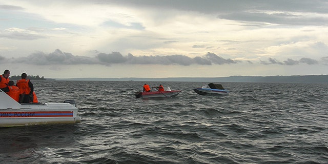 July 10: In this photo provided by Russia Emergency Situations Ministry press service, shows rescue boats trying to locate passengers of a tourist boat that sunk on the Volga River, in central Russia.